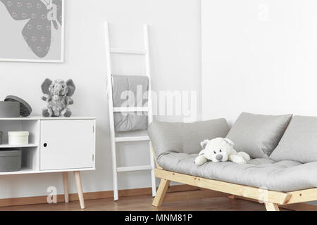 Two fluffy stuffed animals in the white and grey room for kid Stock Photo