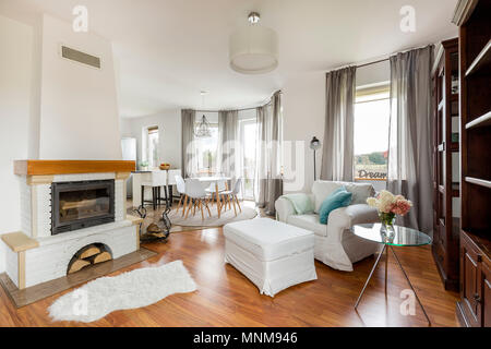 Cozy light flat interior with new furniture, fireplace and wooden floor panels Stock Photo
