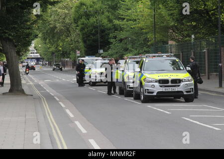 White City Close, Wood Lane Estate, London, UK. 18th May 2018.  Armed Police raid a property near Westfield in West London in view of passers-by during evening rush hour. Credit: Adam Constantine Stock Photo