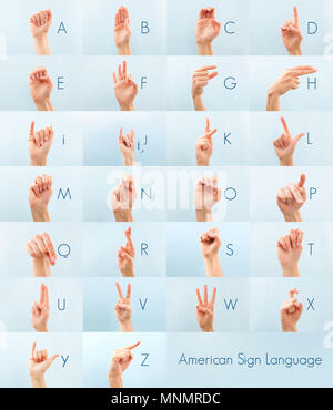 American sign language . Female hand showing alphabet isolated on blue background. Stock Photo