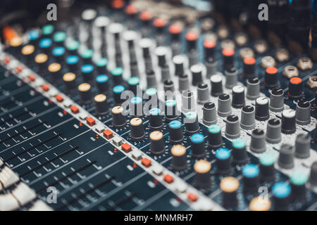 Buttons and knob switches of audio mixer control panel or sound editor, cinematic tone. Digital music technology, concert event, DJ instrumental equip Stock Photo