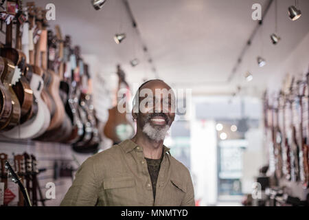 Portrait of a small business owner in a guitar store Stock Photo