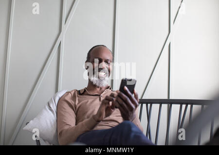 African American senior male using smartphone Stock Photo
