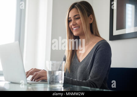 Young woman using laptop Stock Photo