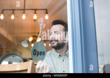 Small business owner opening store Stock Photo
