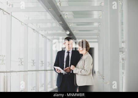 Business people having meeting in modern office using digital tablet Stock Photo