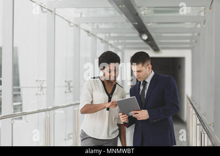 Business people having meeting in modern office using digital tablet Stock Photo