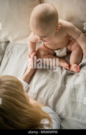 Mother with baby girl (12-17 months) in bed Stock Photo