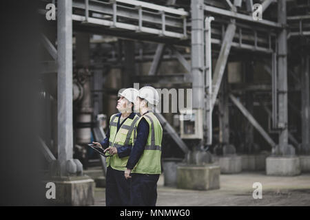 Industrial workers using a digital tablet on site Stock Photo