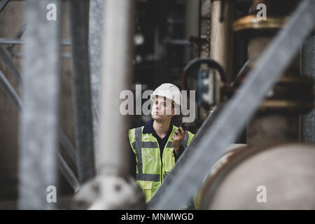 Industrial worker using radio on site Stock Photo