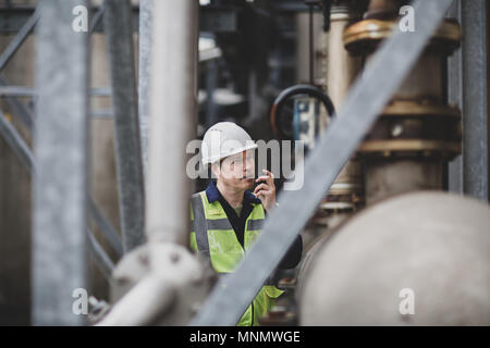 Industrial worker using radio on site Stock Photo