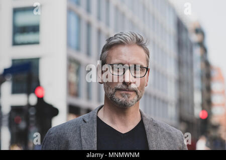 Portrait mature male outdoors in city Stock Photo