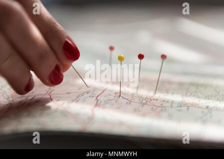 Woman applying pins on map Stock Photo