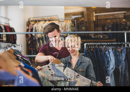 Millennial couple in a vintage clothing store Stock Photo