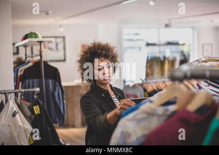 Store manager checking stock in a clothing store Stock Photo