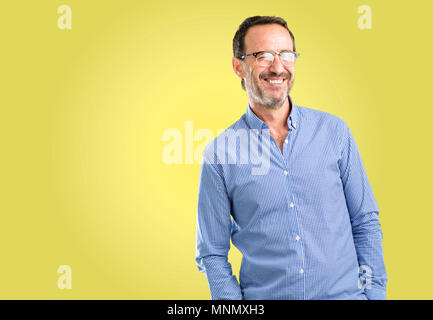 Handsome middle age man blinking eyes with happy gesture Stock Photo