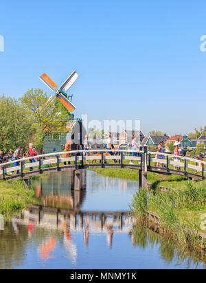 Zaanse Schans, Netherlands - May 08, 2018: People Walking On A Bridge in Zaanse Schans Neighbourhood Stock Photo