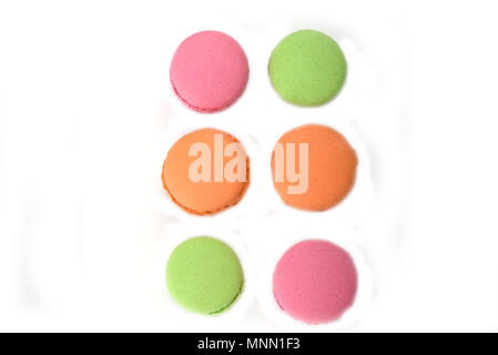 Green, orange and pink french macaroons isolated on white background Stock Photo