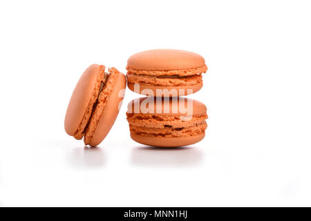 Three orange macaroons isolated on white background Stock Photo