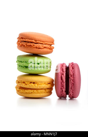 Pyramid of three macaroons and pink one nearby isolated on white Stock Photo
