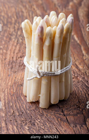 bunch of white asparagus on dark wood Stock Photo