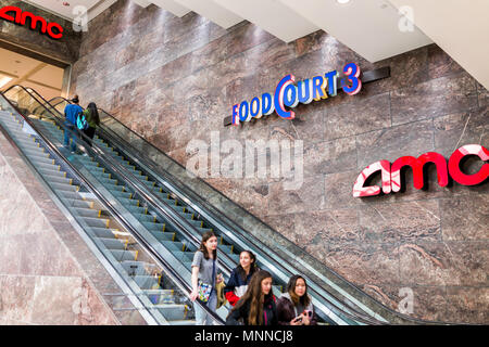 Tysons, USA - January 26, 2018: AMC Movie Theater in Tyson's Corner Mall in Fairfax, Virginia by Mclean with people walking on escalator Stock Photo