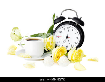 Cup of morning coffee, sweets with coconut flakes, bouquet of yellow roses, white butterfly and black vintage alarm clock isolaled on white background Stock Photo