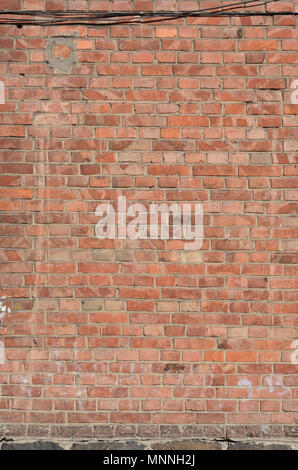 Weathered and stained old brick wall background. Texture of an old wall of several floors with lots of rows Stock Photo