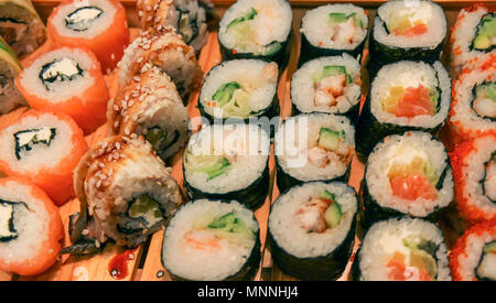 Japanese rolls on wooden plate close up Stock Photo