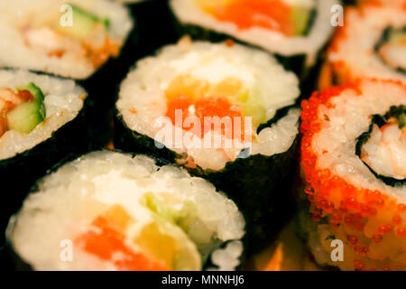 Japanese rolls on wooden plate close up as background Stock Photo