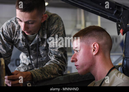 364th Training Squadron aircraft electrical-environmental apprentice course students talk at Sheppard Air Force Base, Texas, March 15, 2018. The E-E apprentices talk about the oxygen regulator in the cockpit. The regulator is connected to a green tank that is located directly below the pilot inside the aircraft's nose. The apprentices also talk about how to replace the regulators. Stock Photo