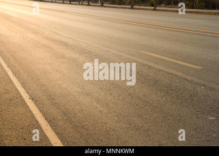 road up hill to the mountain top at at sunny sunset. Stock Photo