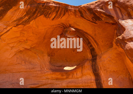 Eye of the eagle Big Hogan. Pothole natural arch eroded in sandstone. Navajo Tribal Park of Monument Valley, Arizona, Utah, USA Stock Photo