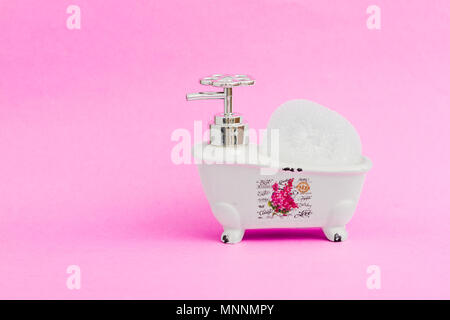 Decorative ceramic mini claw foot bathtub soap dish with bath sponge Stock Photo