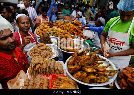 Dhaka, Bangladesh. May 18, 2018. Traditional iftar items on sale at makeshift shop at chawkbazar  in Old part of Dhaka, Bangladesh on May 18, 2018. Dhakaâ€™s residents gathered at the iftar market to buy traditional ifter items, which are Barobaper Polay Khay, giant beef, chicken and mutton roasts, pigeon roast, koel roast, kima roll, kima paratha, borhani, doi bora and different types of kebabs, including Shami, Suti, Jali, Irani, Tika, vegetables, sweets, milk and other ingredients. Â© Rehman Asad / Alamy Stock Photo Stock Photo
