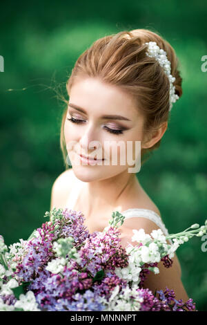 Beautiful young woman in the blossoming garden Stock Photo - Alamy