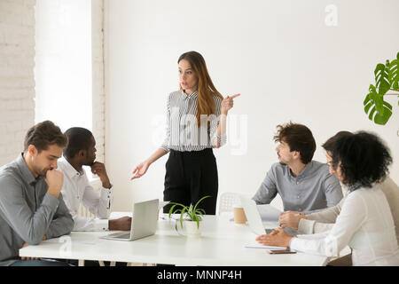 Female executive firing african employee for bad work or miscond Stock Photo