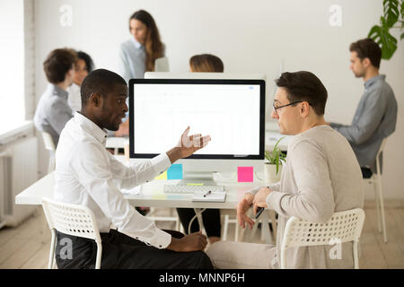 Serious multiracial colleagues having discussion brainstorming p Stock Photo