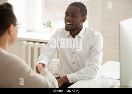 Smiling attractive african american businessman handshaking new  Stock Photo