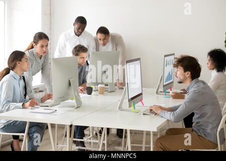 Focused multiracial business people working online on computers  Stock Photo