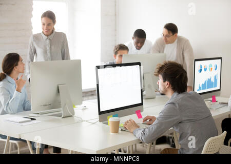 Diverse corporate employees group working together using compute Stock Photo