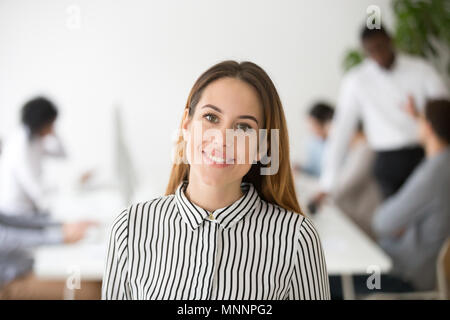 Attractive woman business leader smiling looking at camera heads Stock Photo
