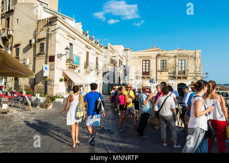 Siracusa, Italy - August 17, 2017: Street with people around in the old town of the historic city of Siracusa in Sicily, Italy Stock Photo
