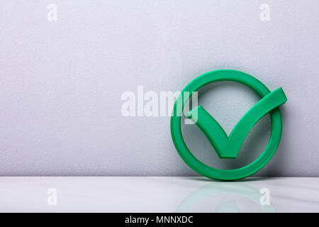 Green check mark icon on lid of cardboard parcel boxes stack on blue ...