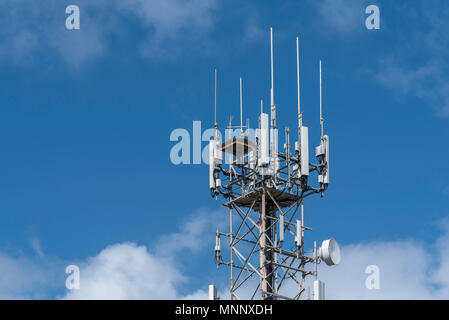 A cell phone or mobile phone tower in country NSW, Australia with a specially built platform for a local Osprey bird family nest Stock Photo