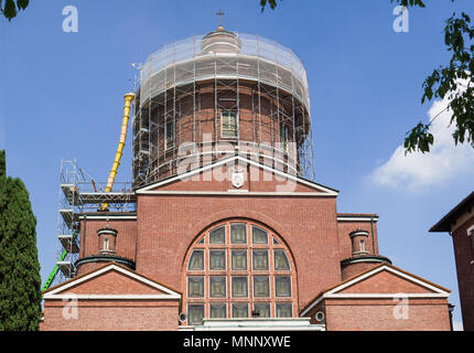 scaffolding on the brick facade of a church undergoing renovation Stock Photo