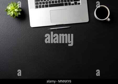 Business background with modern laptop on black table Stock Photo