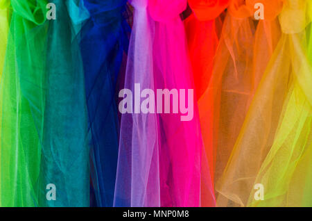 Rainbow fabric background with interesting colors and textures Stock Photo