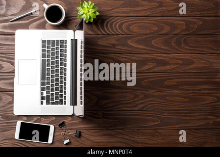 Overhead shot of office desktop with laptop Stock Photo