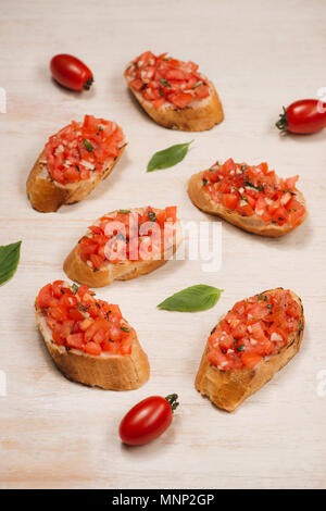 Italian bruschetta with roasted tomatoes, mozzarella cheese and herbs on a paper Stock Photo